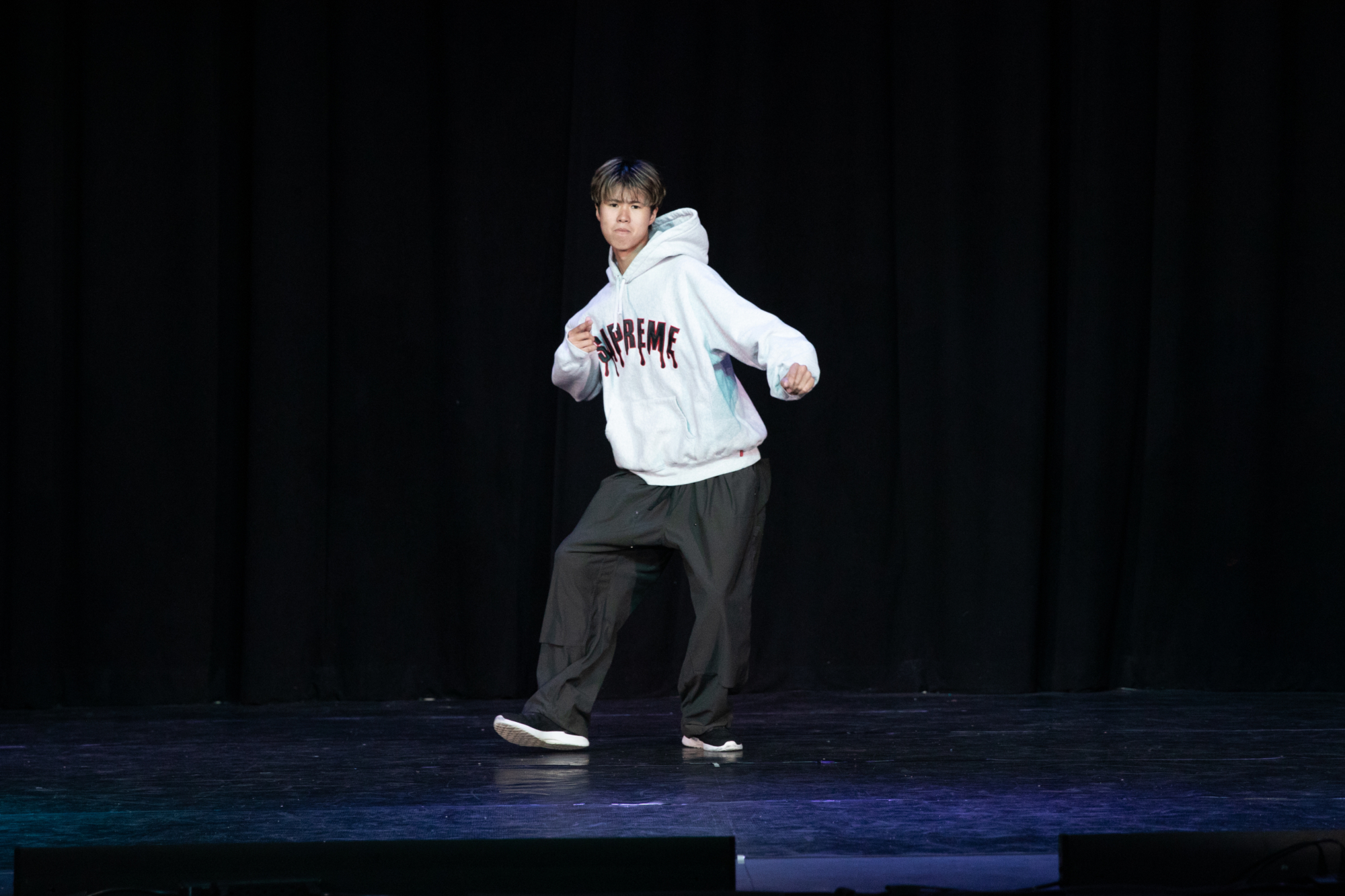 Student performing a solo hip-hop routine on stage