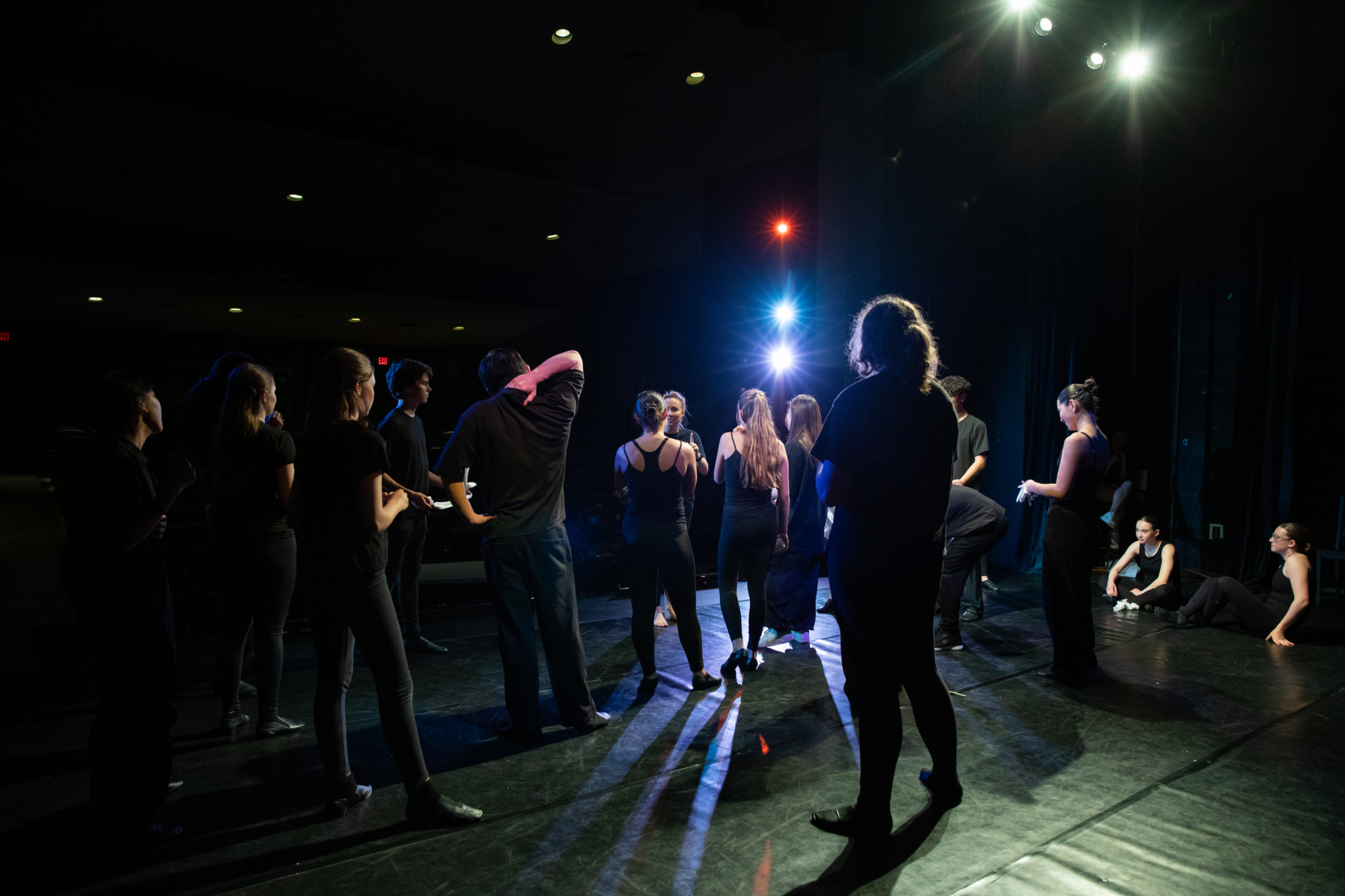 Dancers gathered on stage during rehearsal