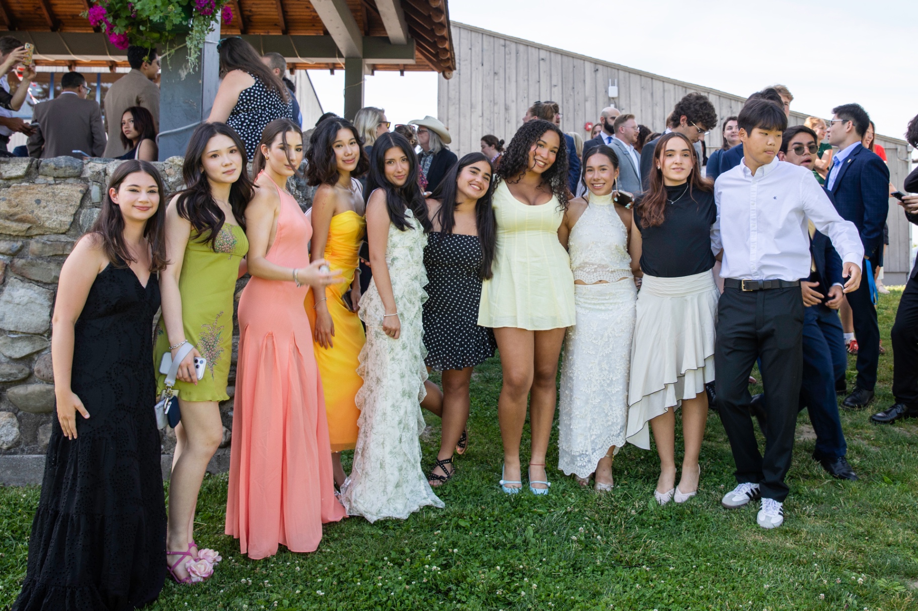 Students dressed for a formal occasion on the lawn