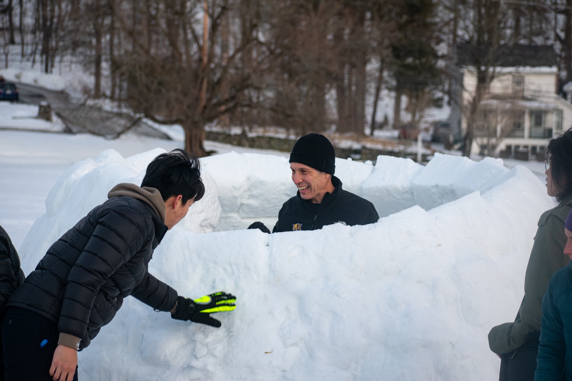 Students building together outdoors in the snow