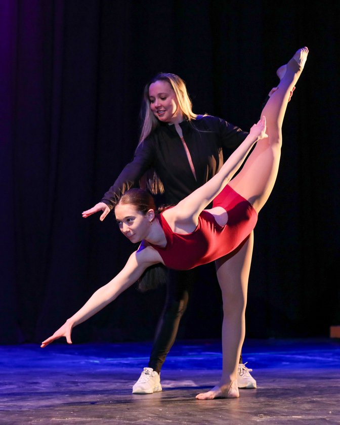 Jeanette Jacobson coaching a student dancer on stage