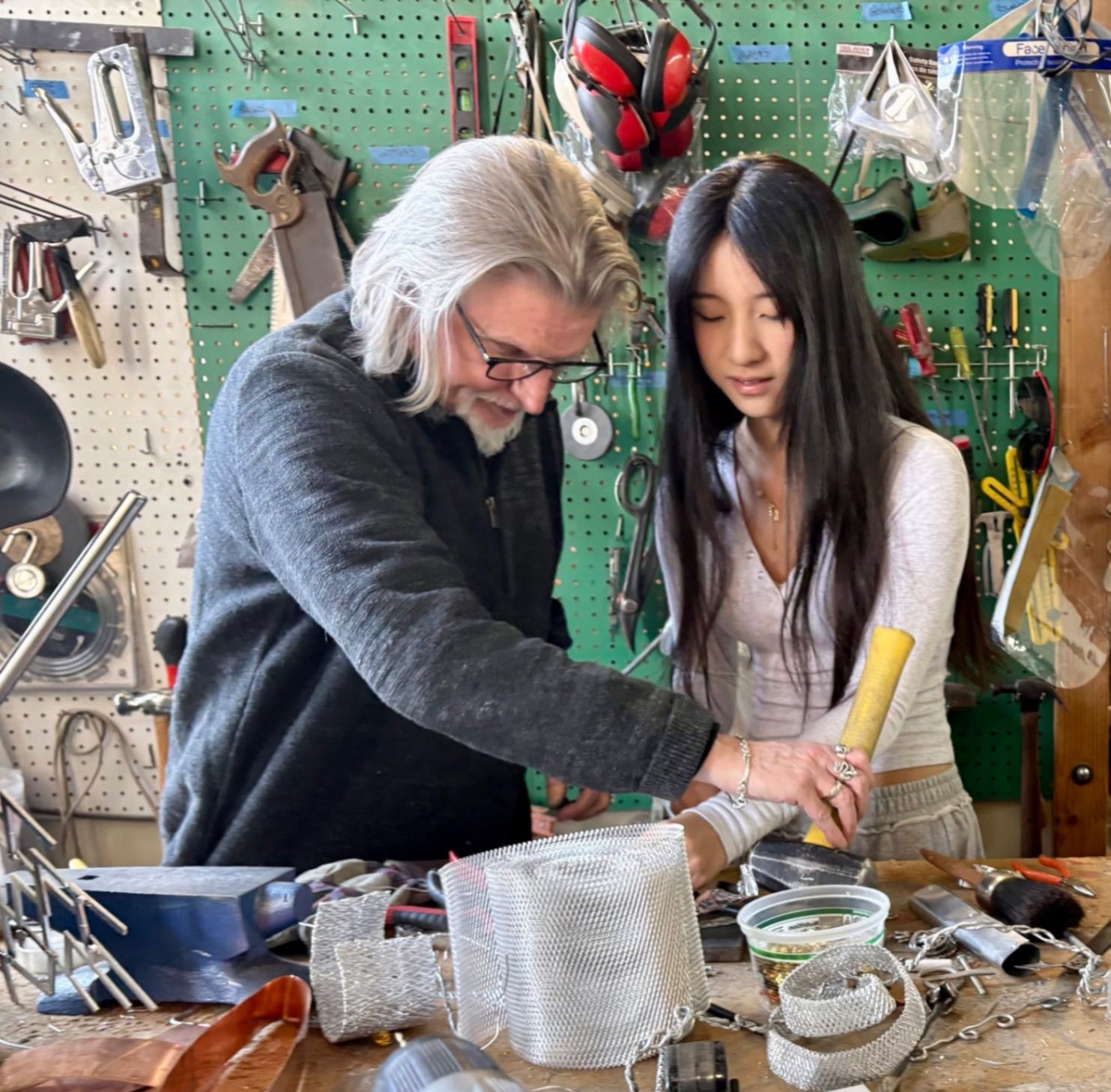 Faculty and student working together in the jewelry and metal arts studio