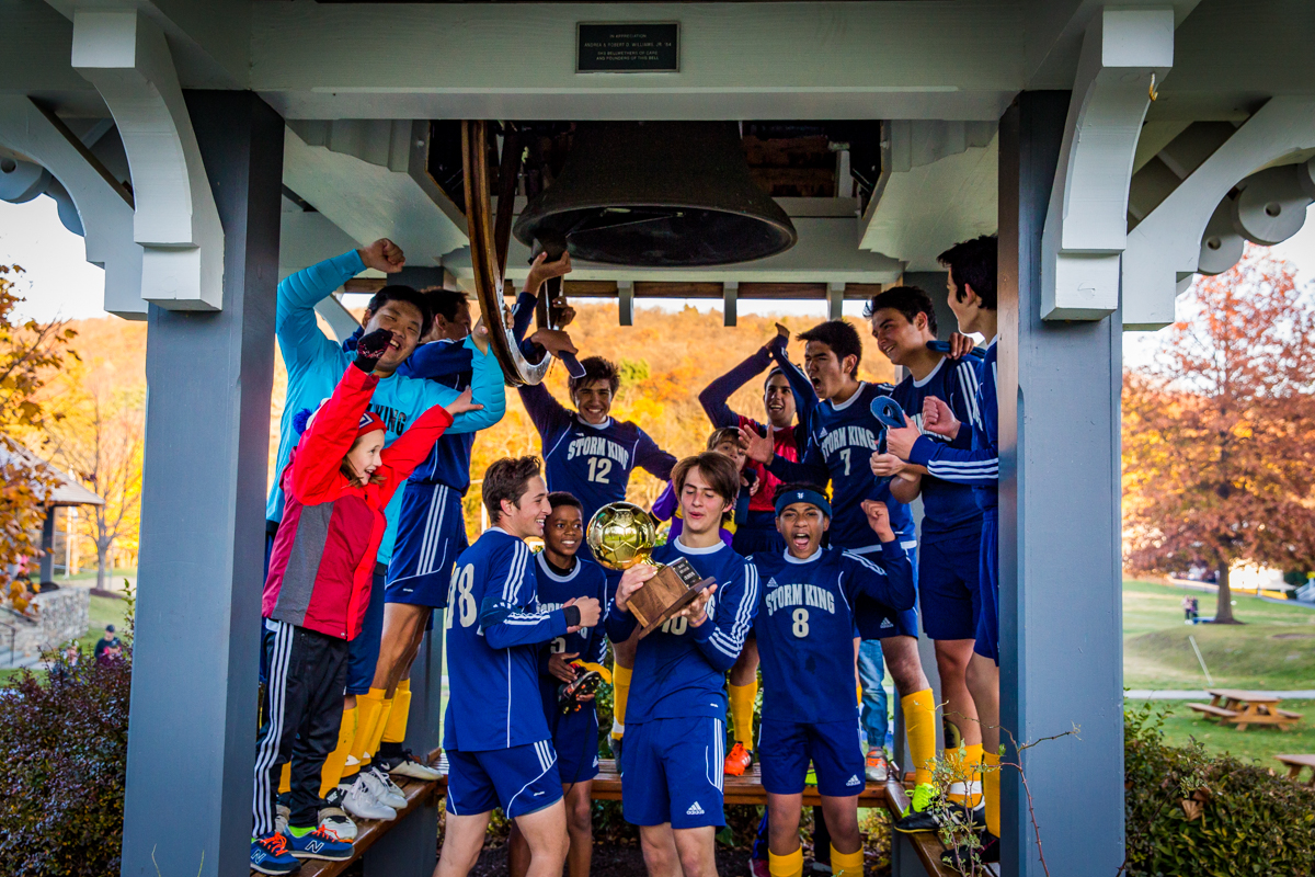 SKS Boys soccer team members ringing the bell after their HVAL victory