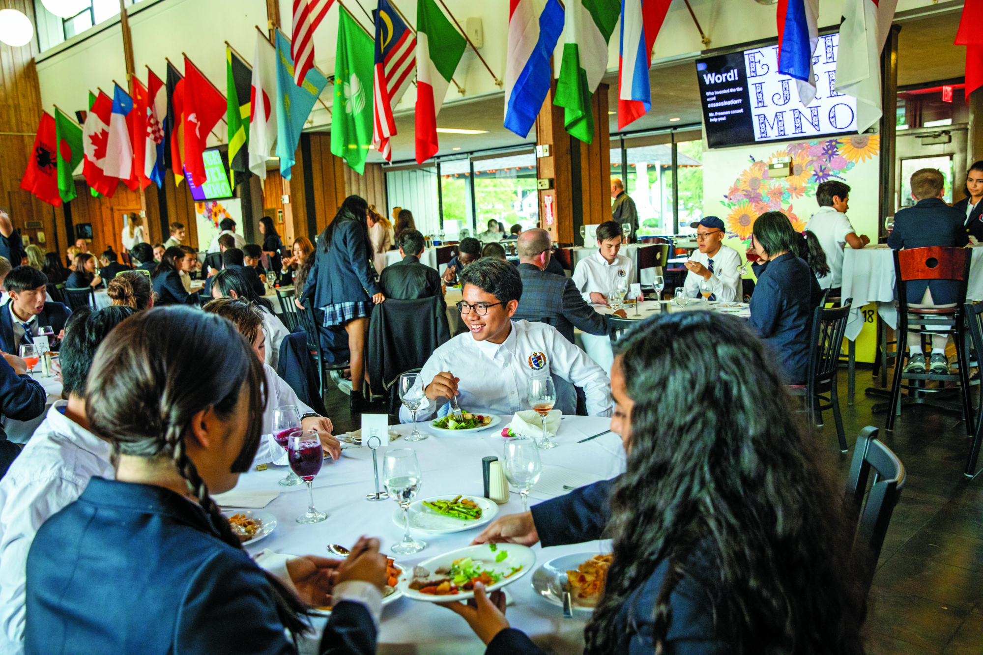 Formal Dinner in the Storm King dining hall beneath the flags of every student nation