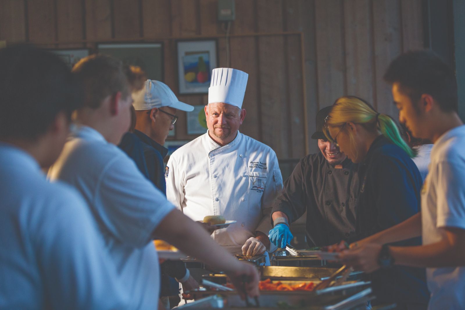 A Storm King chef serves students at the family-style dinner line