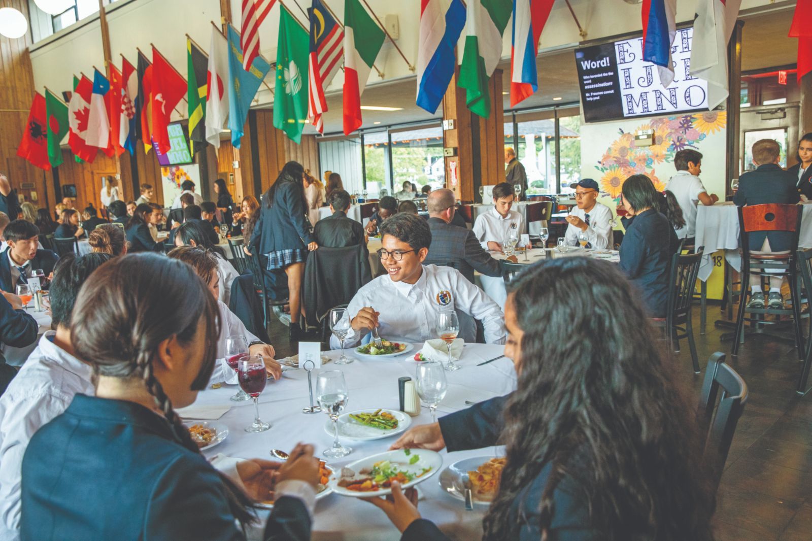 Formal Dinner in the Storm King dining hall beneath the flags of every student nation