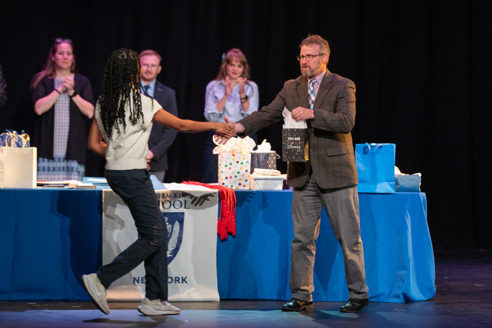 Storm King School faculty applaud a student at the Spring Academic Awards ceremony