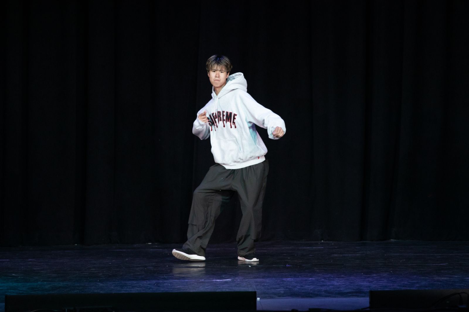 Student performing a solo hip-hop routine on stage