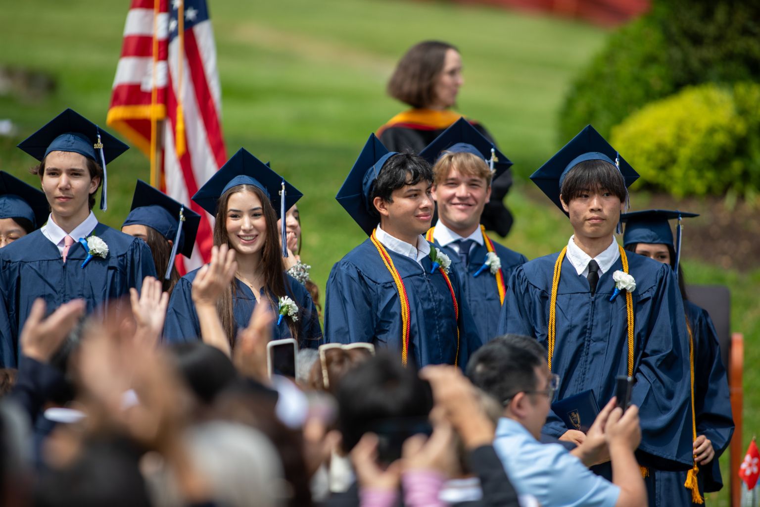 Storm King School graduates in navy caps and gowns on the commencement lawn