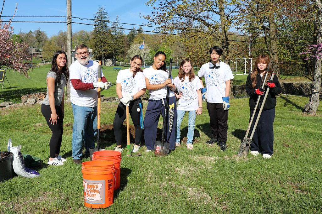 Storm King students and teacher planting trees on campus