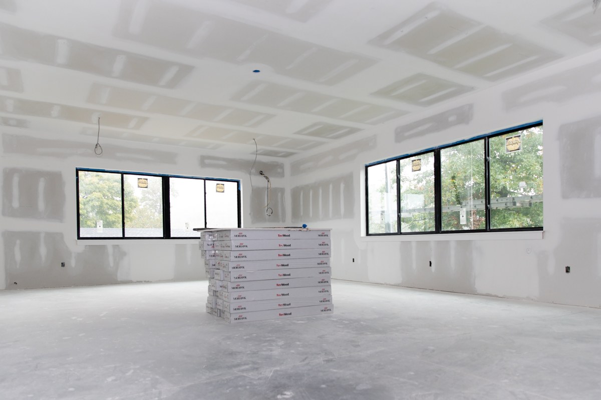 Drywalled classroom in the Fischer Academic Center with large windows looking out onto trees