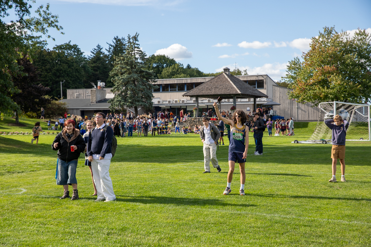 Storm King cross country runner celebrates with classmates and fans on campus after the Storm King Invitational