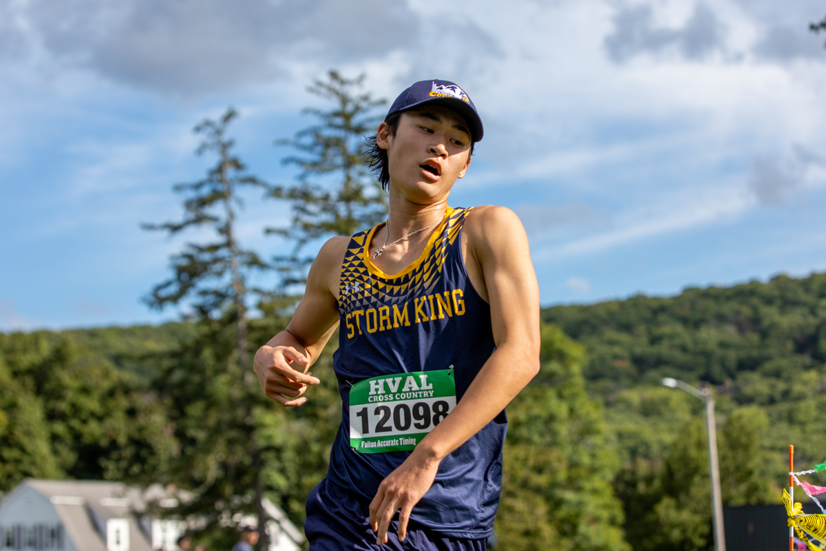 Storm King cross country runner in a Cougars cap during an HVAL cross country meet
