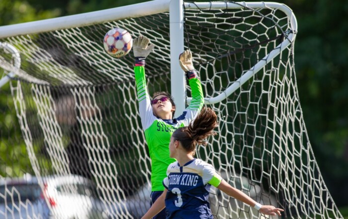 Storm King girls varsity soccer goalkeeper leaps to make a save at the crossbar