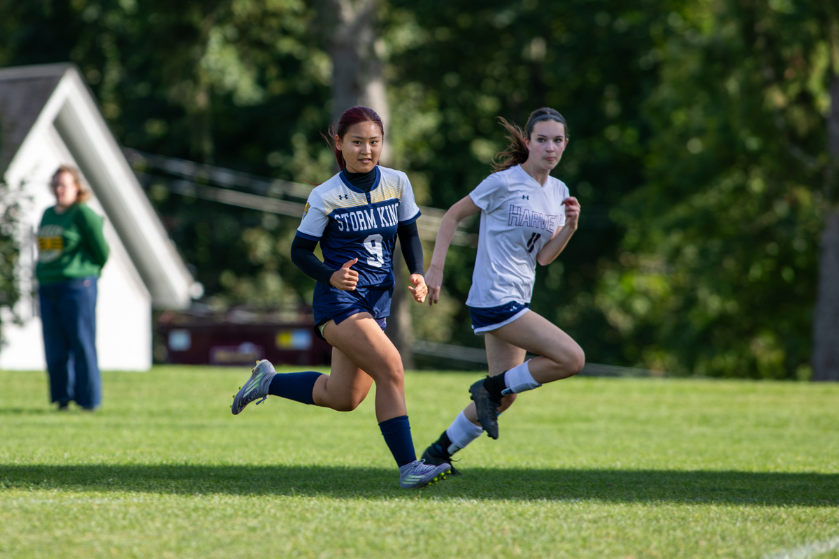 Storm King girls soccer player races for the ball against a Harvey School defender