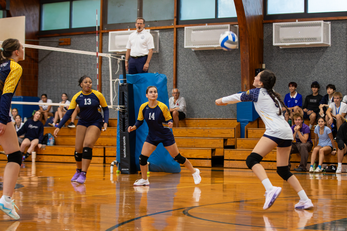 Storm King girls volleyball player digs the ball as teammates look on