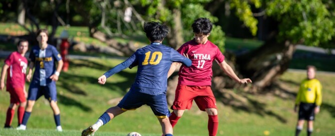 Storm King Cougars boys varsity soccer player number 10 drives past a NYMA defender during an October home win