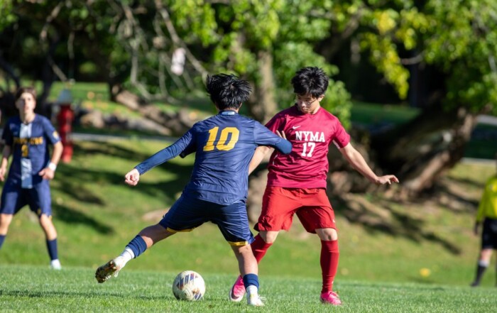 Storm King Cougars boys varsity soccer player number 10 drives past a NYMA defender during an October home win