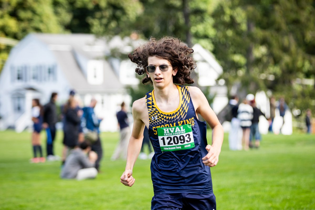 Storm King School cross country runner in sunglasses strides through an HVAL cross country meet