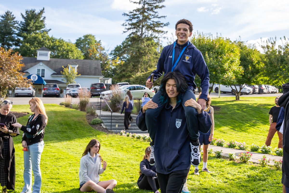Storm King cross country teammates celebrate a strong finish with a piggyback ride on campus