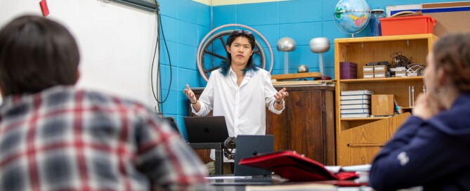 Storm King School senior Eric Wang ’27 presents his independent bobcat research to a class as students listen