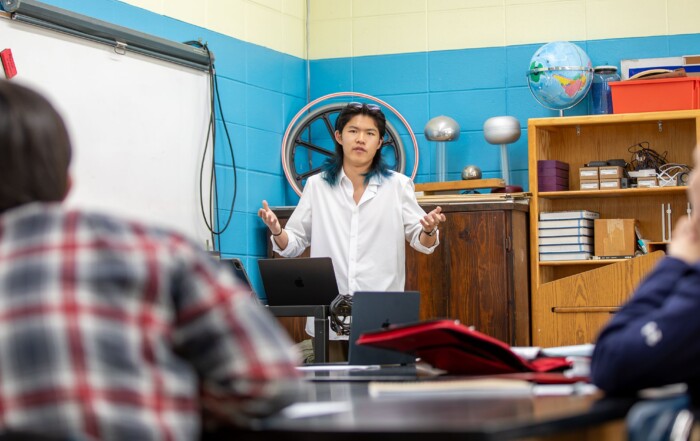 Storm King School senior Eric Wang ’27 presents his independent bobcat research to a class as students listen