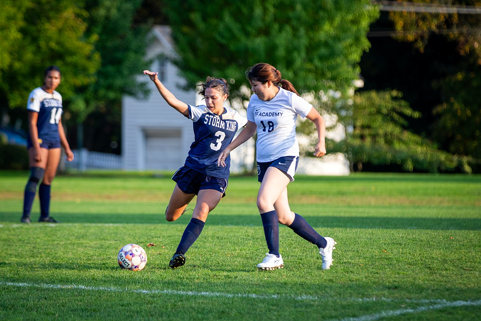 Storm King girls varsity soccer player battles for the ball against EF Academy