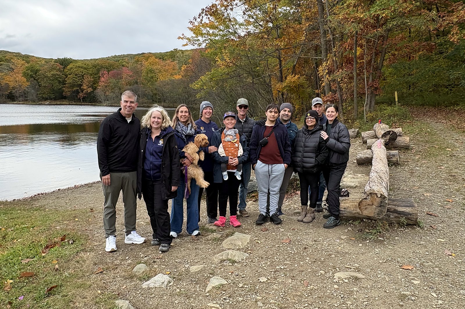 Storm King families gather by the water on a fall hike in the Hudson Valley during Family Weekend