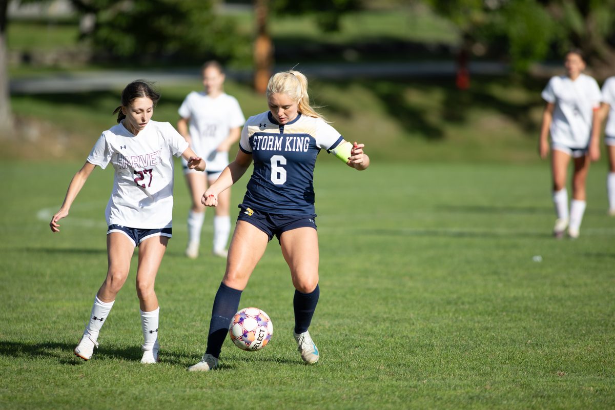 Storm King girls varsity soccer captain controls the ball while shielding a defender